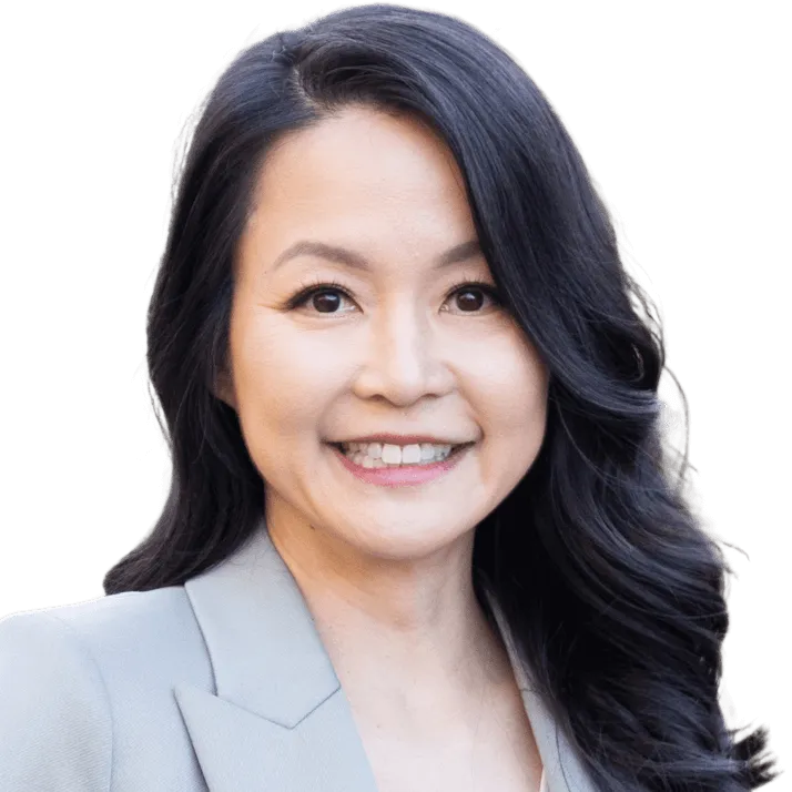 A woman with long black hair wearing a suit.